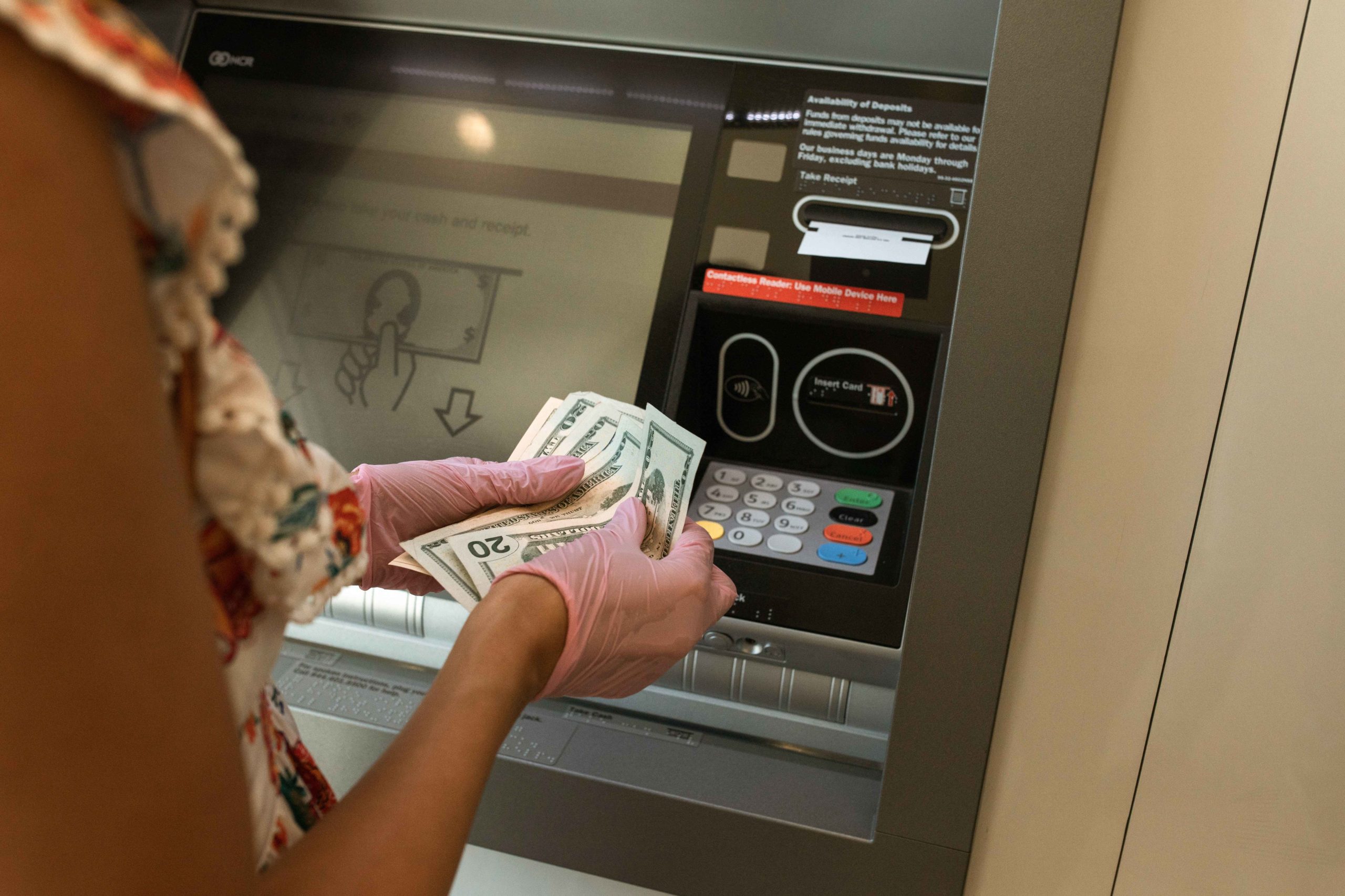 Person withdrawing money from an ATM 