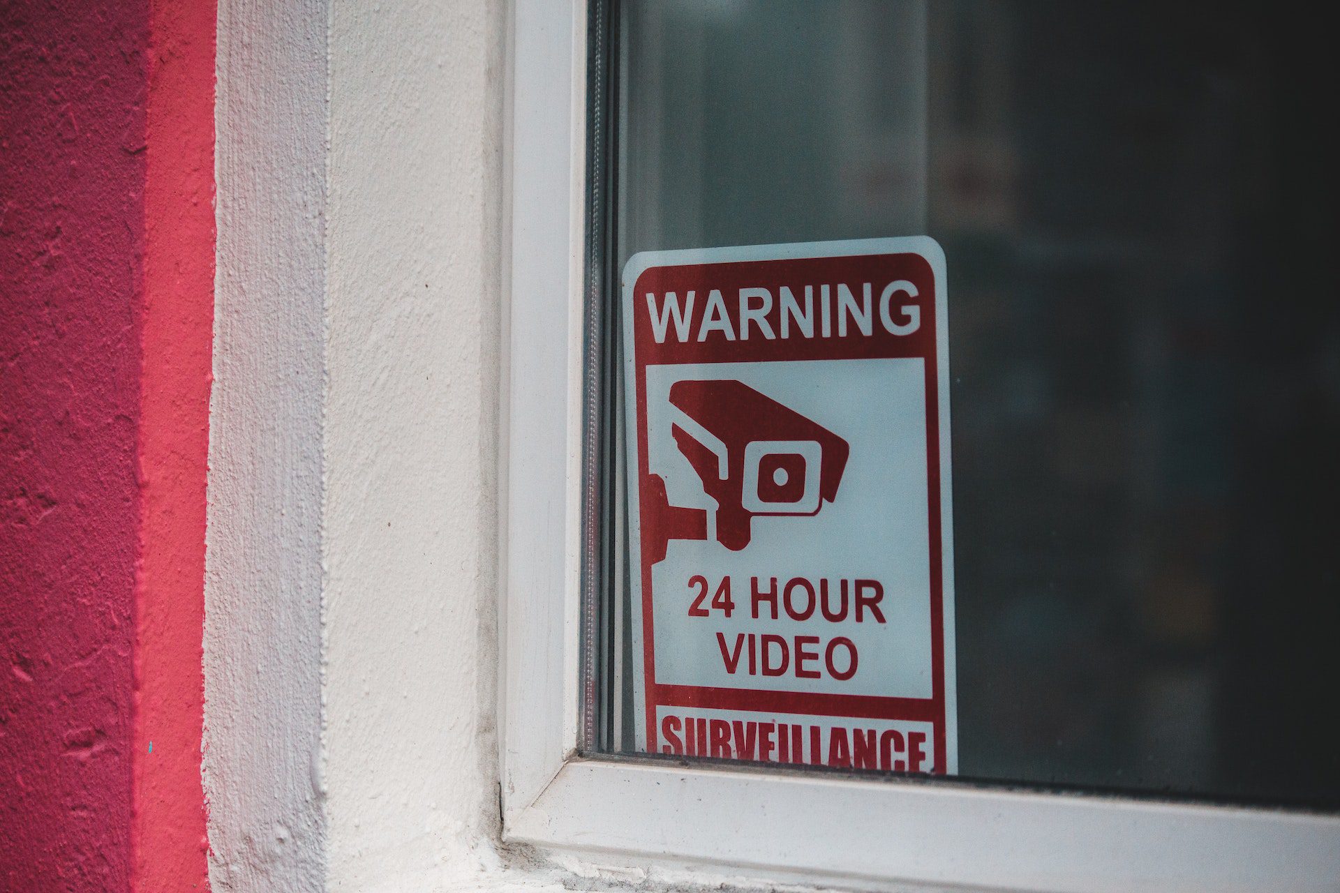 Sign in a window with warning “24-hour video surveillance”